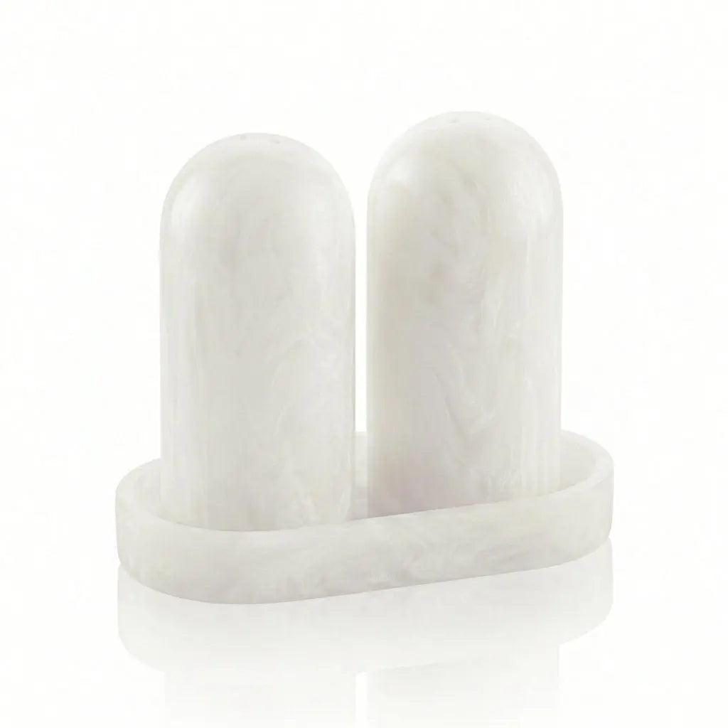 Pair of white resin salt shakers with matching tray, modern cylindrical design for tabletop dining and hostess gifting.