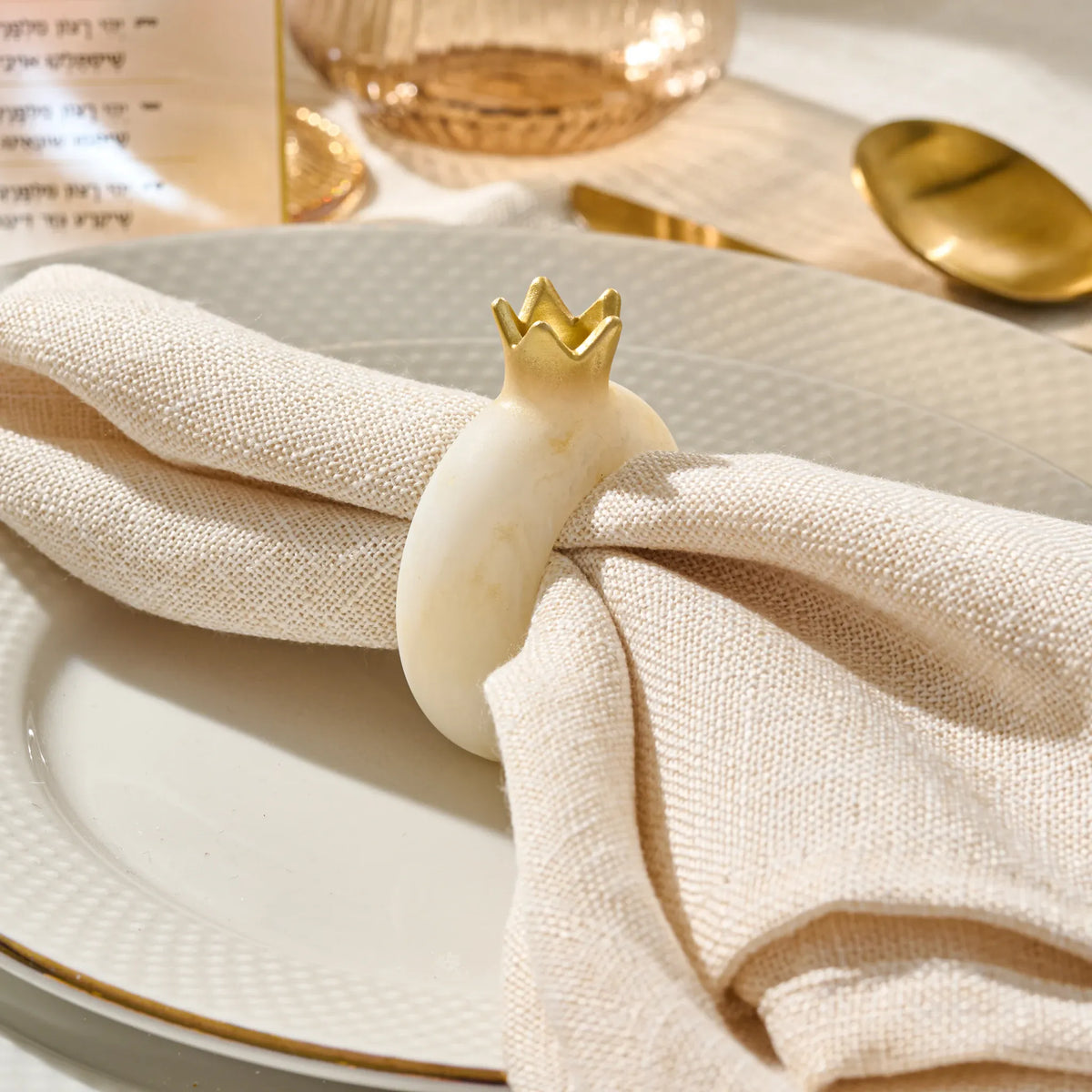 Gold resin pomegranate napkin ring for a Rosh Hashanah place setting