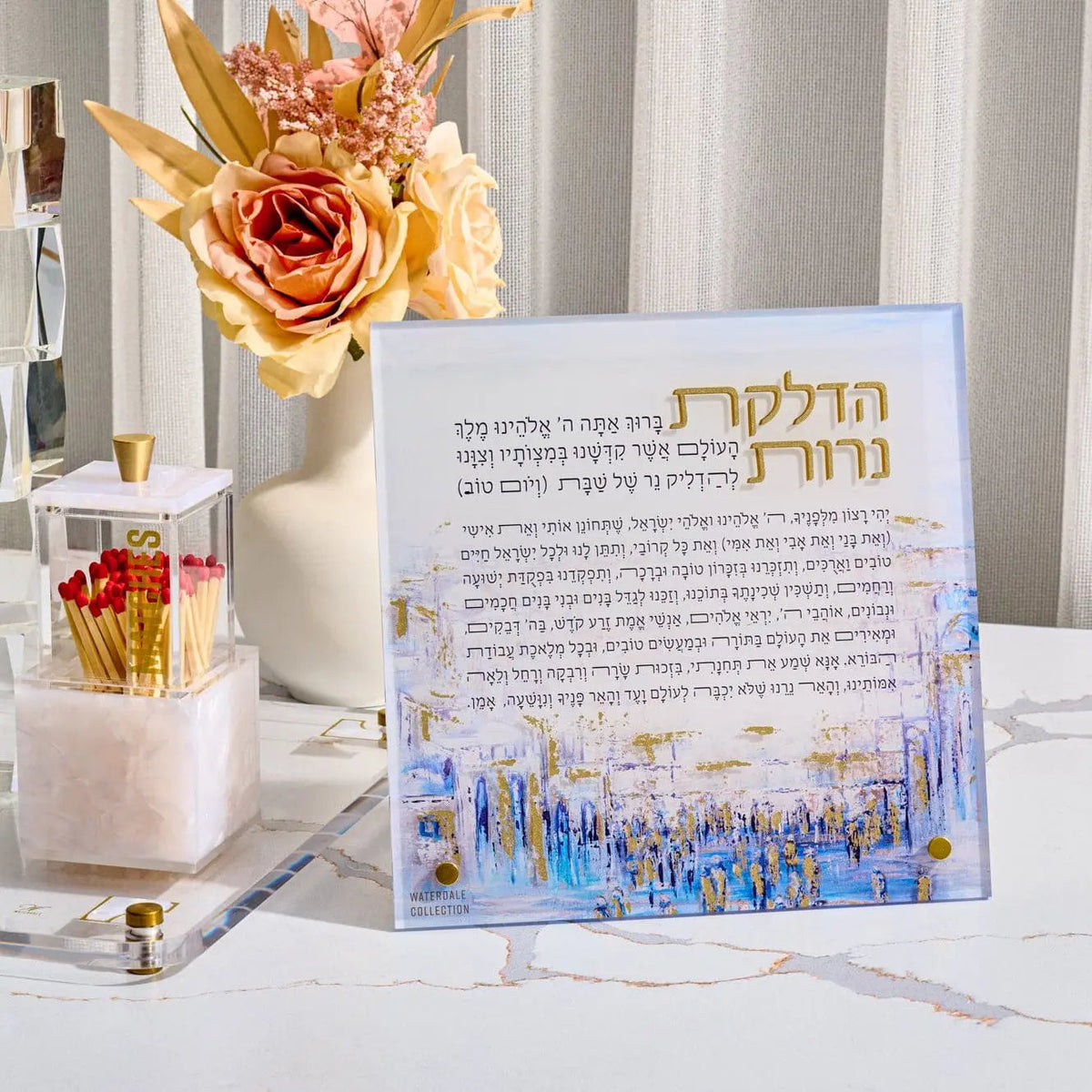 Rose faux floral arrangement in white vase displayed on desk with prayer book and gold accents