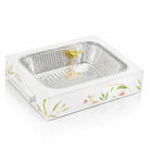 White floral bird ceramic pan holder with gold accents, featuring a ribbed aluminum insert and pearl marble finish base for serving dishes.