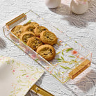 Floral bird ceramic bread tray displaying baked goods, featuring colorful botanical design and matching cloth napkin for entertaining and Shabbat table settings.