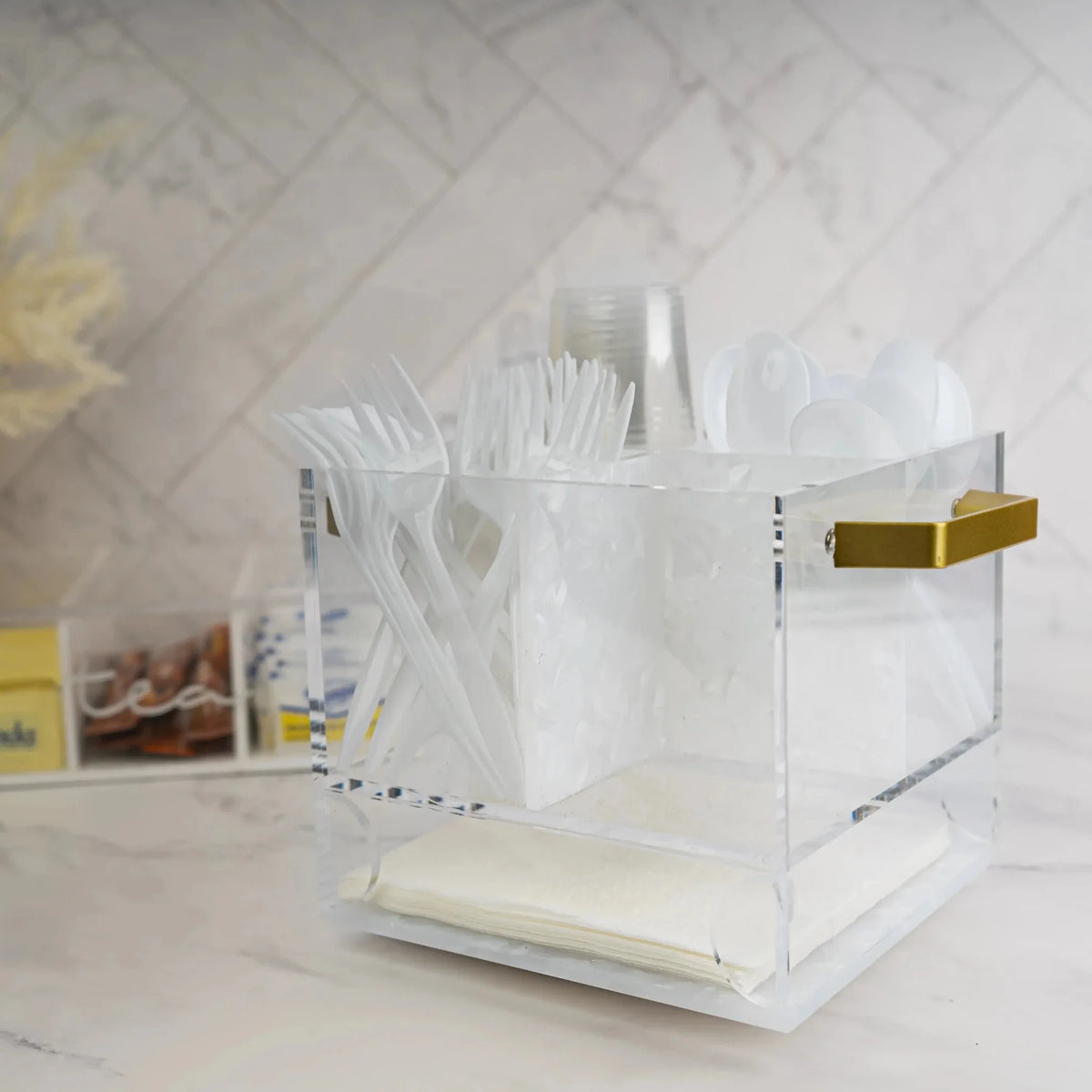 Pearlstone Swivel Silverware Caddy with white marble finish and gold accents, displayed on a light countertop with tableware organizer compartments.