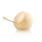 Cream-colored resin salt cellar with a spoon, featuring a glossy finish and elegant curved design from Waterdale Collection.