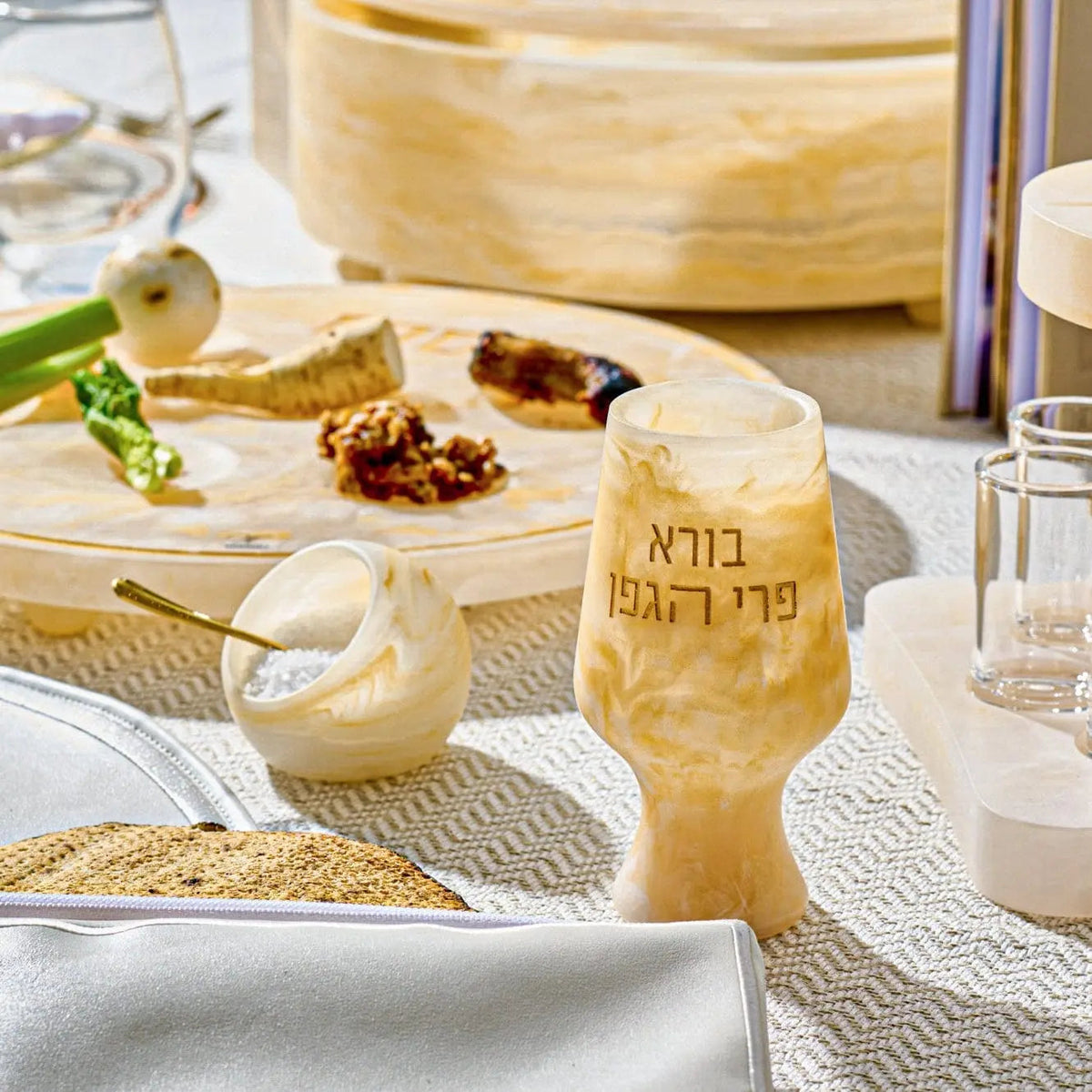 Cream-colored resin salt cellar with gold spoon on white table setting, part of Waterdale Collection's elegant tabletop accessories.