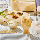 Cream-colored resin salt cellar with gold spoon on white table setting, part of Waterdale Collection's elegant tabletop accessories.