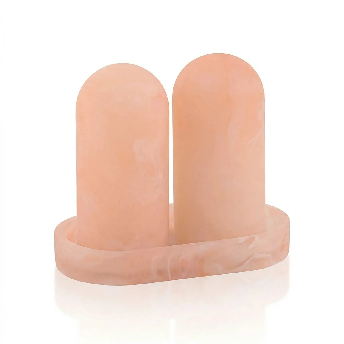 Peach resin salt shaker set with matching tray, featuring two cylindrical shakers on a rectangular base from Waterdale Collection.