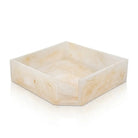 Square cream-colored resin napkin holder with natural stone-like texture, perfect for Pesach tabletop entertaining