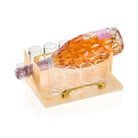 Resin liquor serving set with pineapple-shaped amber bottle and four small glasses on wooden base, perfect for Shabbat or hostess entertaining.