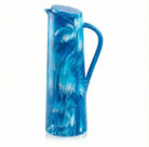 Blue resin pitcher with swirled marble pattern, featuring a handle and pour spout, ideal for serving beverages and tabletop display.
