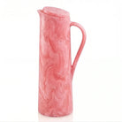 Pink resin pitcher with textured surface and curved handle from Waterdale Collection's tabletop collection.