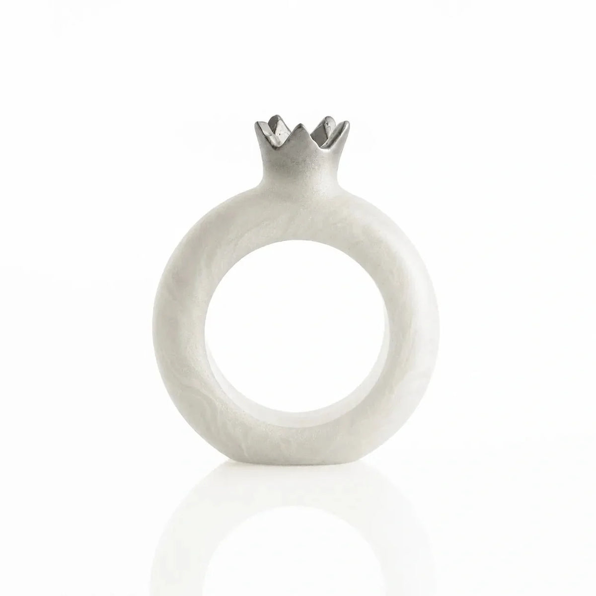 Silver resin pomegranate napkin rings framing napkins at each seat