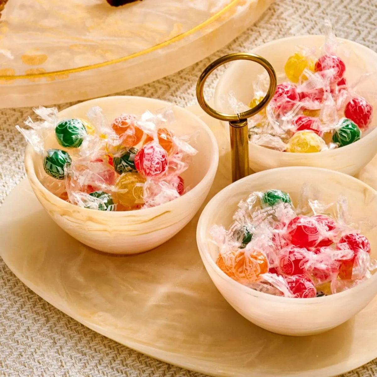 Waterdale Collection resin round dip bowls in cream with colorful floral designs, displayed on wooden serving board with dip holder handle.