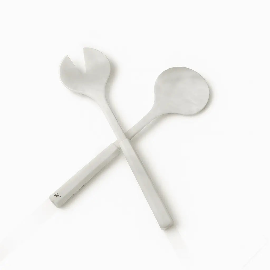 Pair of white resin salad servers with long handles crossed, part of Waterdale Collection serveware collection for entertaining and special occasions.