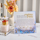 Rose faux floral arrangement in white vase displayed on desk with prayer book and gold accents