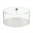 Round clear resin cake dome with white marble base and chrome knob, ideal for serving and displaying desserts at gatherings.
