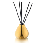 Teardrop-shaped gold reed diffuser with black sticks in a tall bottle, perfect for home fragrance and decor.