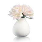 White teardrop vase with pale pink faux roses and greenery, elegant tabletop floral arrangement by Waterdale Collection.